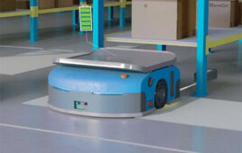 image of a warehouse robot in a warehouse aisle on a capow charging pad.