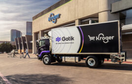 Gatik medium-duty truck with Kroger branding in front of a Kroger store.